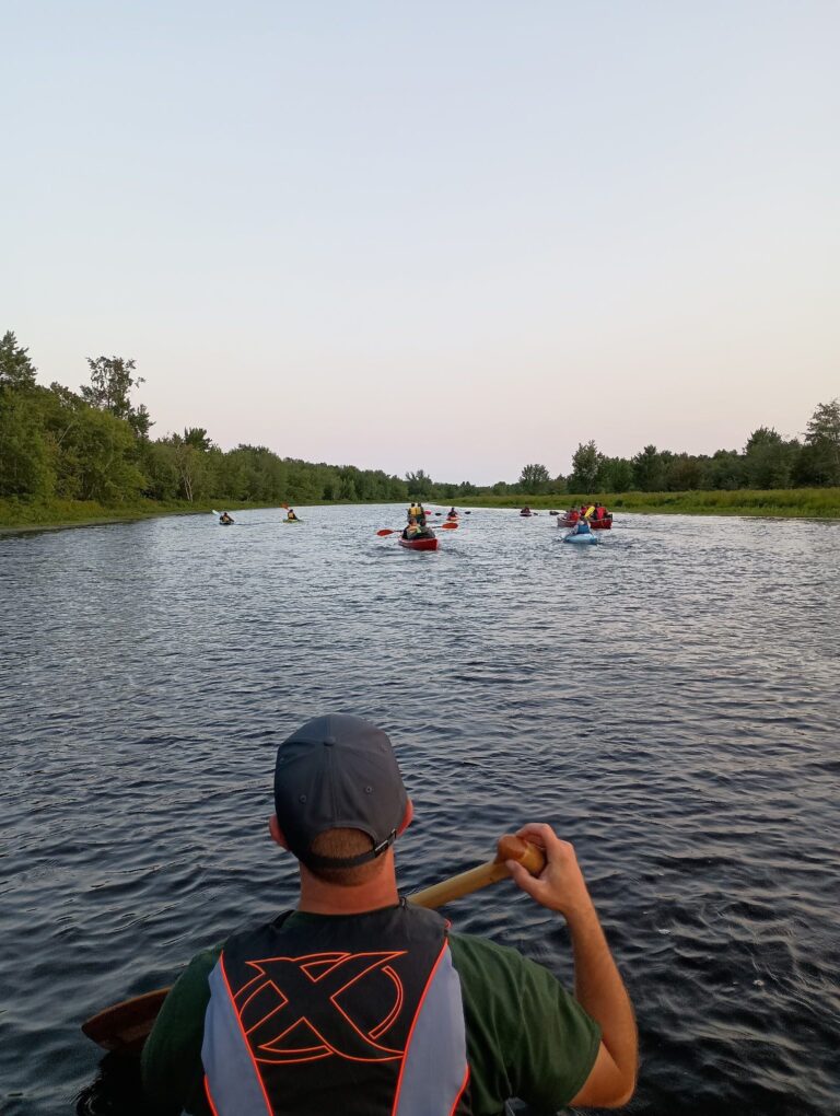 Paddling a canoe on a Maine river on a guided recreational trip