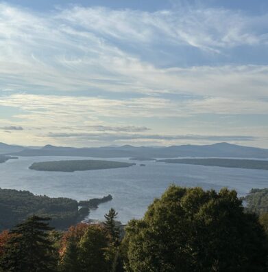 A large Maine lake and its islands seen from a hilltop overlook