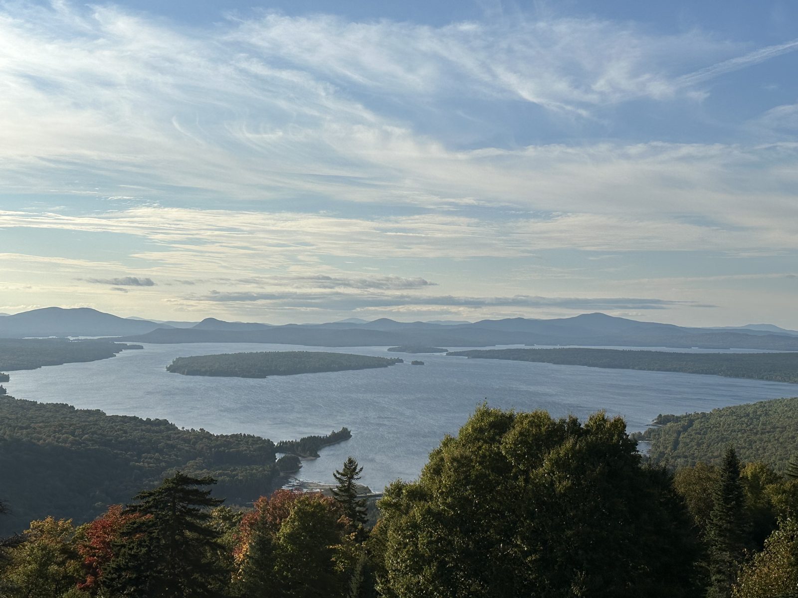 A large Maine lake and its islands seen from a hilltop overlook